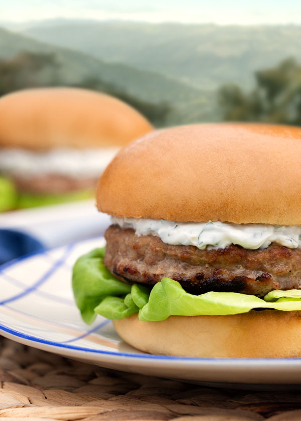 Butterball turkey burger with creamy sauce and lettuce, served on a bun for a fresh summer meal.