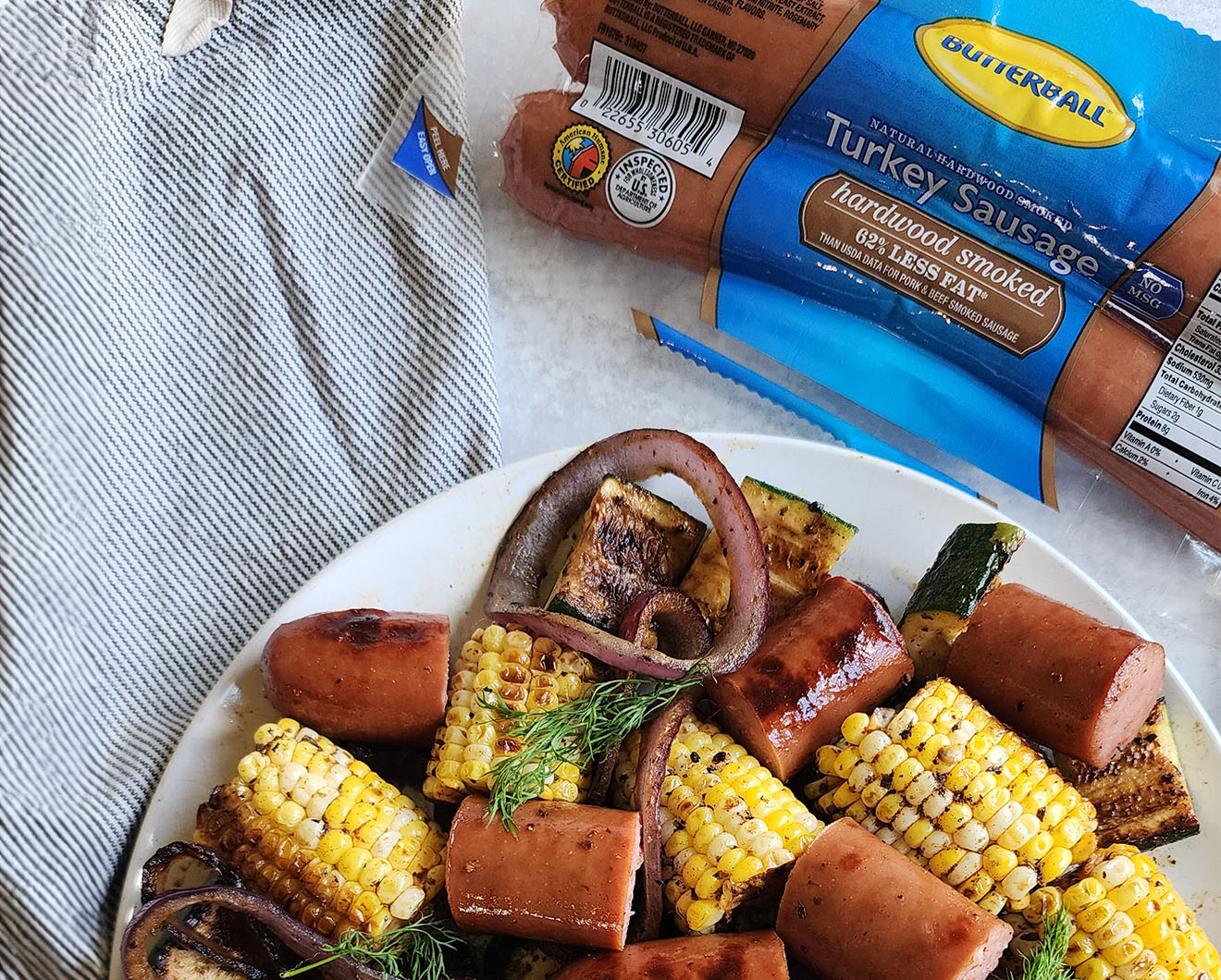 Image of Grilled Sausage and Vegetables with Garlic Butter.
