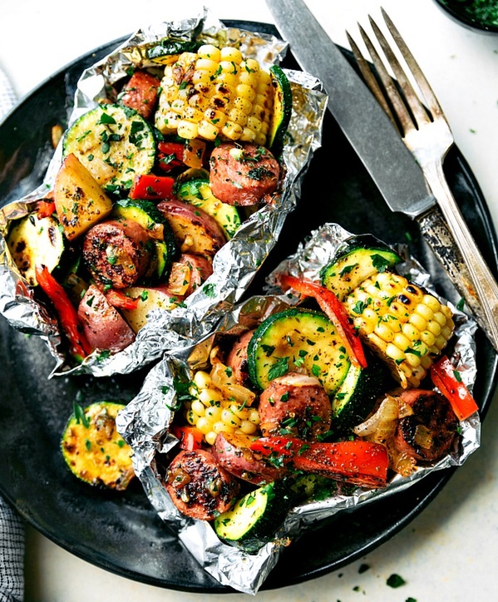 Grilled veggies and turkey sausage in foil packs with corn, zucchini, peppers, and potatoes.