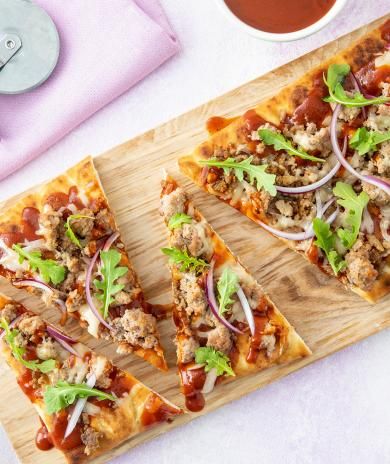 Slice of BBQ ground turkey flatbread pizza arranged on a cutting board.