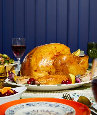 Turkey on a plate as part of a dinner spread.