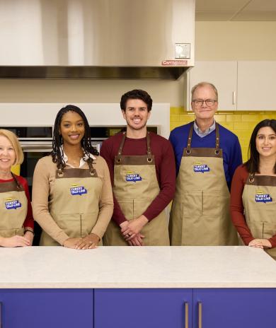 A group of Butterball Turkey Talk Line turkey experts pose in a kitchen.