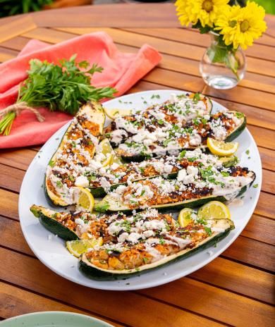 A platter of grilled ground turkey-stuffed zucchini boats.